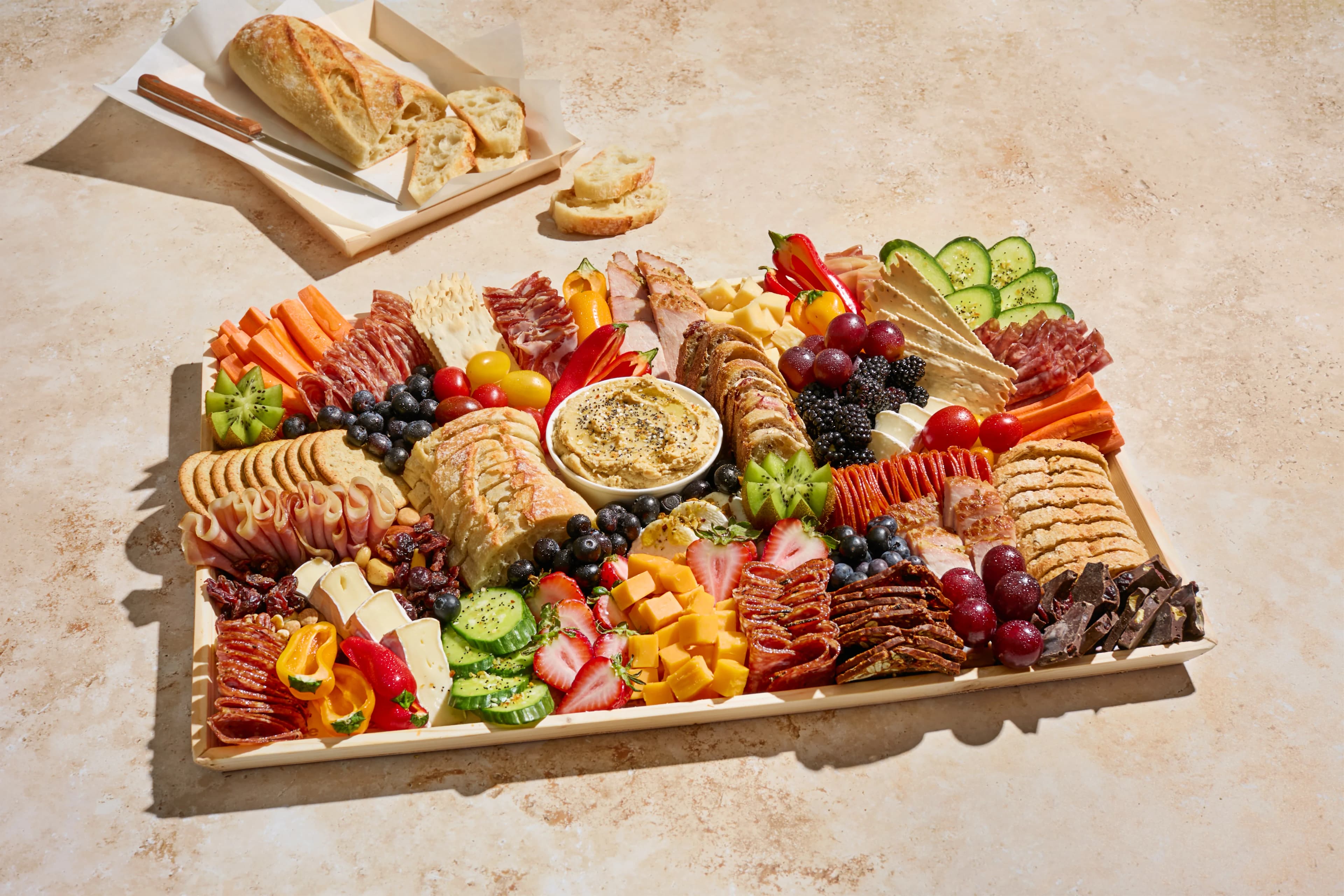 Artisan charcuterie board with assorted cheeses, cured meats, and fresh garnishes